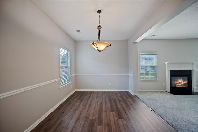 3223 Tallon Ln SW, Atlanta, GA 30311 - unfurnished dining area with dark wood-type flooring, baseboards, and a fireplace with flush hearth