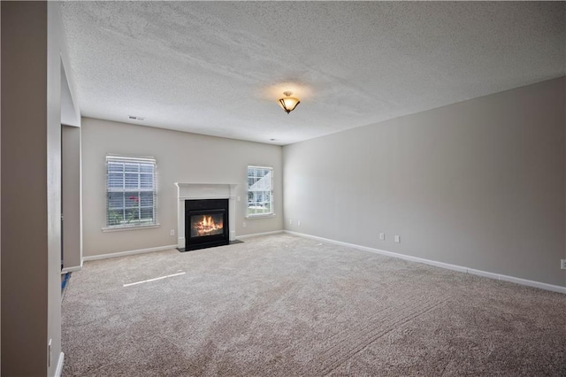3223 Tallon Ln SW, Atlanta, GA 30311 - unfurnished living room with carpet floors, a fireplace with flush hearth, baseboards, and a textured ceiling