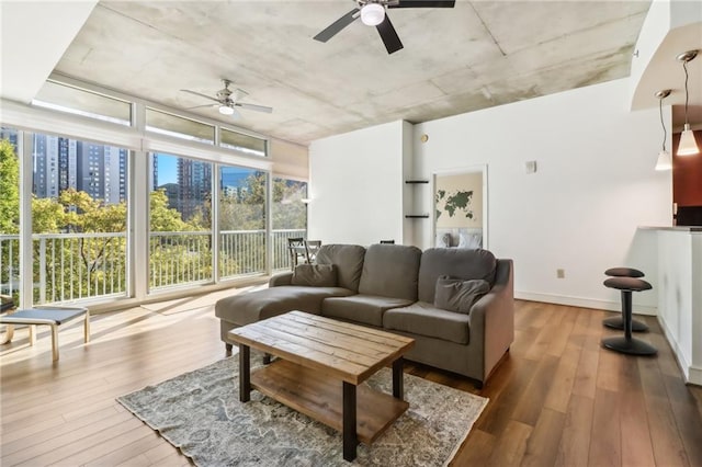 living room featuring hardwood / wood-style flooring, plenty of natural light, and ceiling fan