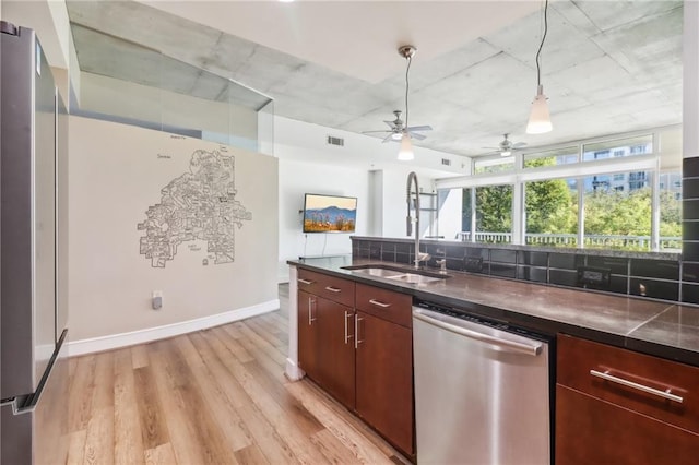 kitchen featuring decorative backsplash, ceiling fan, stainless steel dishwasher, light hardwood / wood-style flooring, and sink