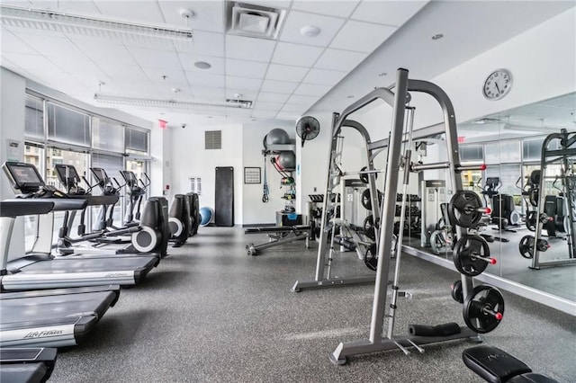 workout area featuring a paneled ceiling