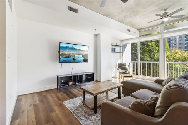 living room featuring ceiling fan and dark hardwood / wood-style floors