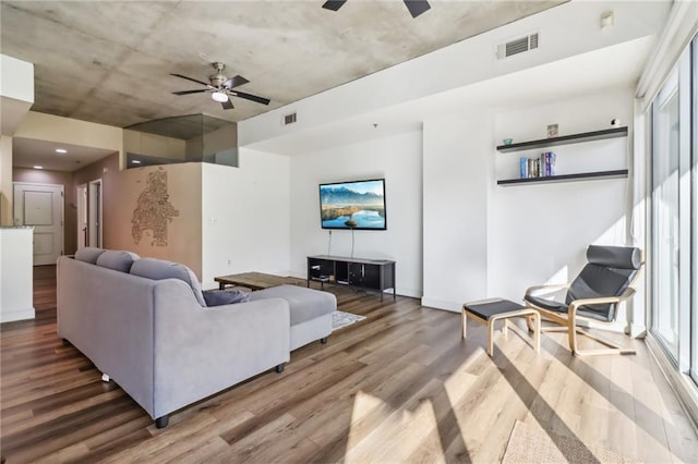 living room with hardwood / wood-style flooring and ceiling fan