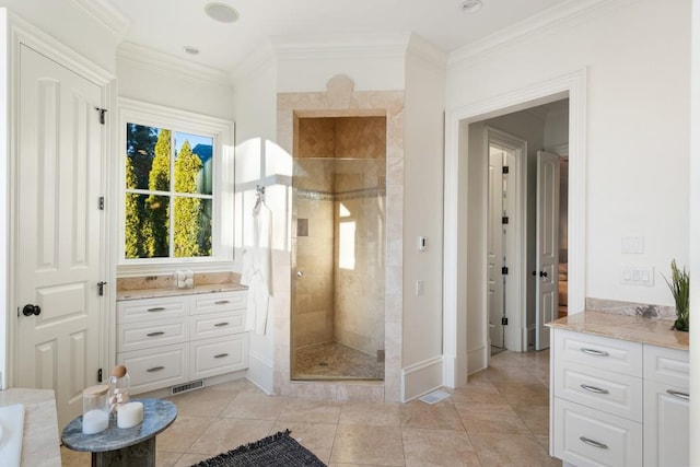 bathroom featuring crown molding, a tile shower, vanity, and tile patterned floors