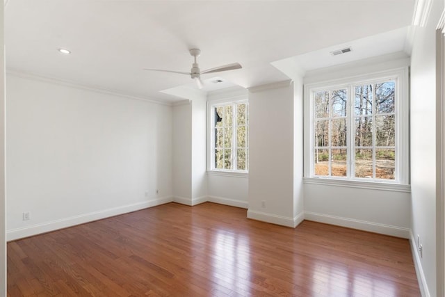 empty room with hardwood / wood-style flooring, ceiling fan, and ornamental molding