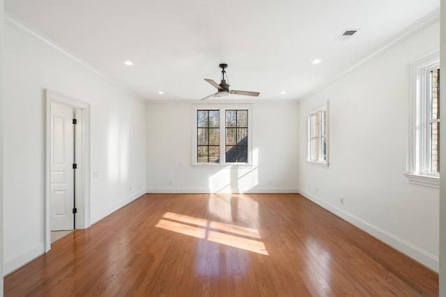 unfurnished room featuring crown molding, wood-type flooring, and ceiling fan