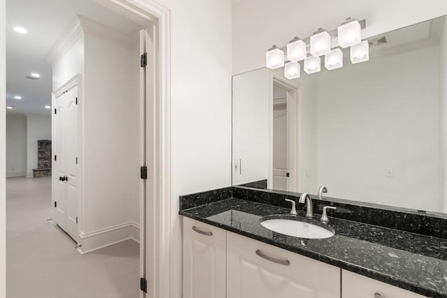 bathroom with crown molding and vanity