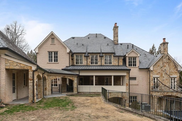 rear view of house with central AC unit and a patio area