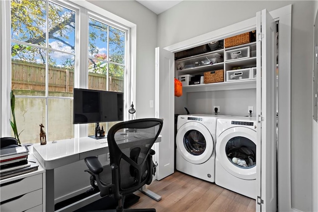 washroom featuring washer and clothes dryer and light hardwood / wood-style floors