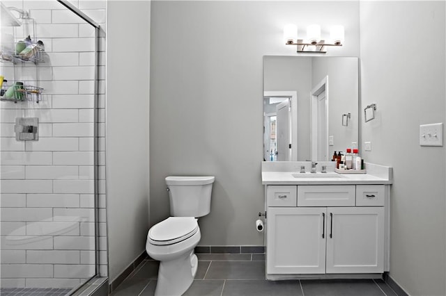 bathroom featuring vanity, toilet, a shower with door, and tile patterned flooring