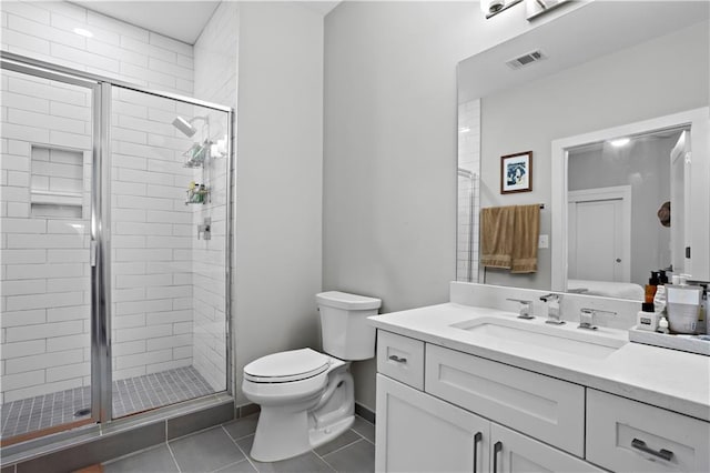 bathroom with tile patterned flooring, vanity, toilet, and walk in shower