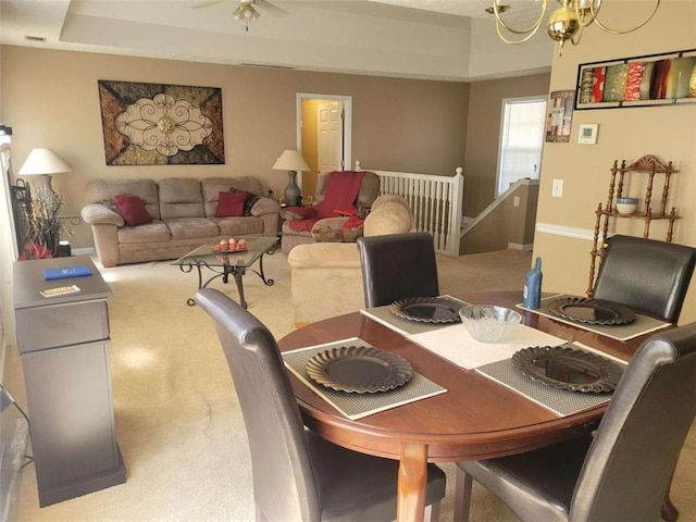 dining room featuring ceiling fan with notable chandelier