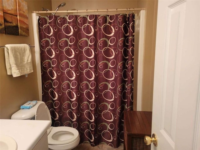 bathroom featuring a shower with curtain, toilet, and vanity