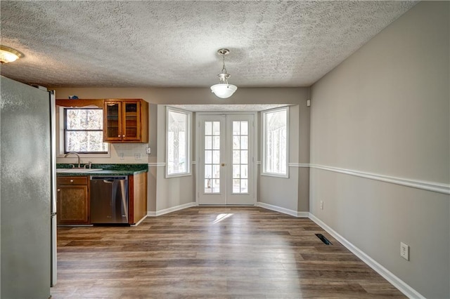 doorway with dark hardwood / wood-style flooring, a healthy amount of sunlight, french doors, and sink