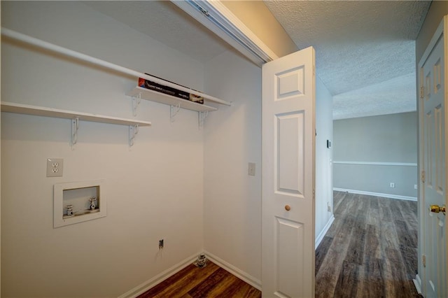 washroom featuring a textured ceiling, dark hardwood / wood-style flooring, and hookup for a washing machine