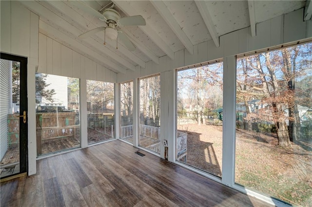 unfurnished sunroom featuring ceiling fan and lofted ceiling with beams