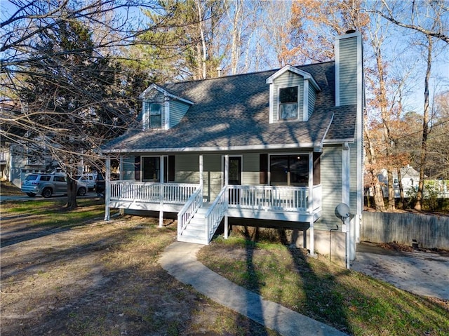 new england style home featuring a porch