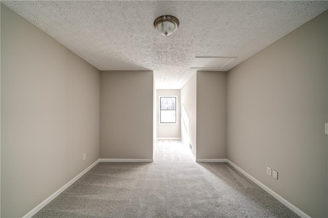 carpeted spare room featuring a textured ceiling