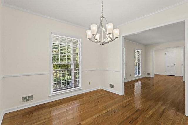 unfurnished dining area featuring crown molding, an inviting chandelier, and dark hardwood / wood-style flooring