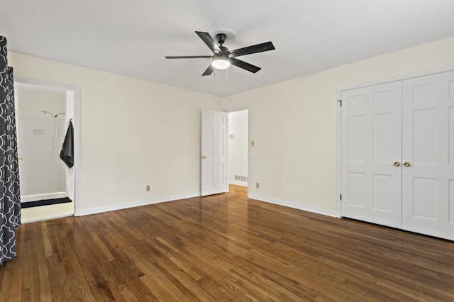 unfurnished bedroom with dark wood-type flooring, ceiling fan, and a closet