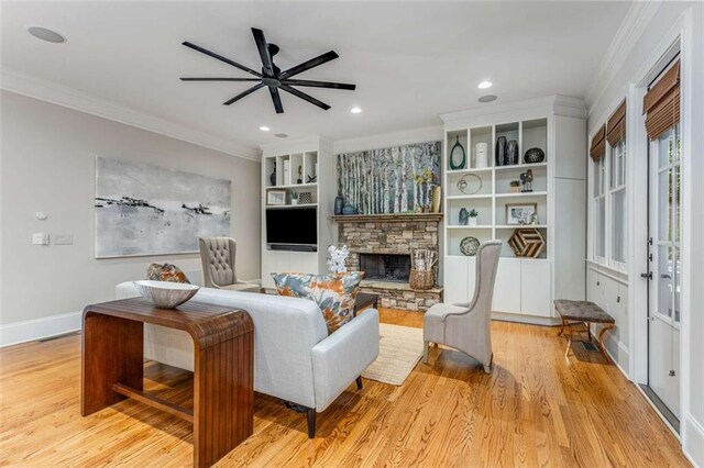 504 S Westminster Way NE, Atlanta, GA 30307 - living area featuring ornamental molding, a ceiling fan, a stone fireplace, light wood-style floors, and baseboards