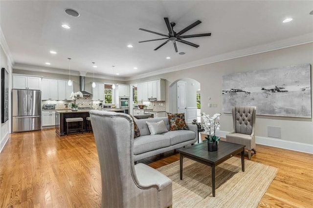504 S Westminster Way NE, Atlanta, GA 30307 - living area with arched walkways, ceiling fan, light wood finished floors, ornamental molding, and recessed lighting