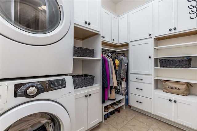 504 S Westminster Way NE, Atlanta, GA 30307 - washroom with stacked washing machine and dryer, cabinet space, and light tile patterned floors