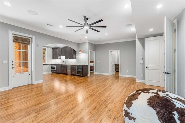 504 S Westminster Way NE, Atlanta, GA 30307 - living area featuring a ceiling fan, beverage cooler, arched walkways, recessed lighting, and light wood-style floors