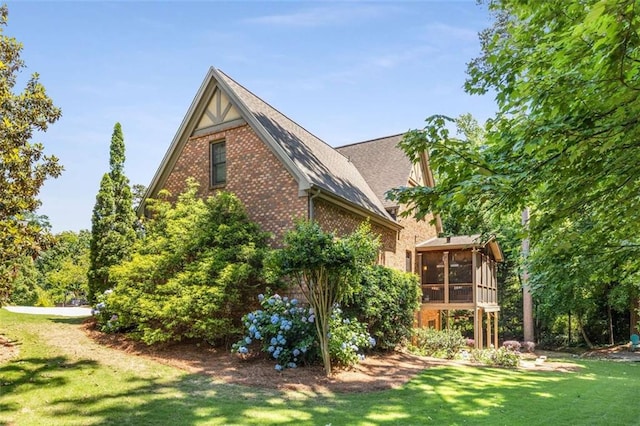 504 S Westminster Way NE, Atlanta, GA 30307 - view of side of home with a sunroom, brick siding, a yard, and a shingled roof