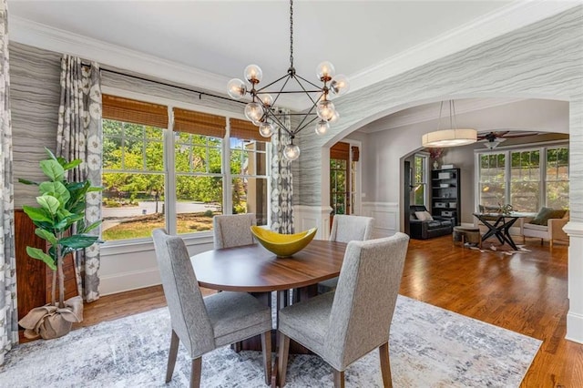 504 S Westminster Way NE, Atlanta, GA 30307 - dining room featuring arched walkways, ornamental molding, a chandelier, plenty of natural light, and wood finished floors
