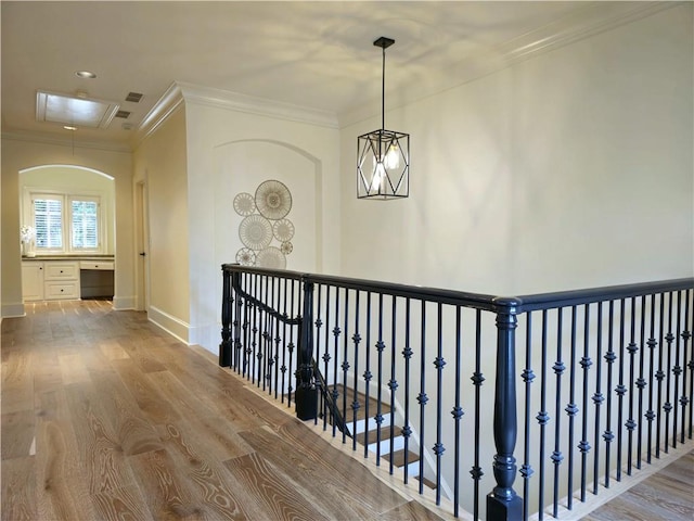 1632 Brookhaven Close NE, Brookhaven, GA 30319 - hallway featuring crown molding, baseboards, wood finished floors, and attic access