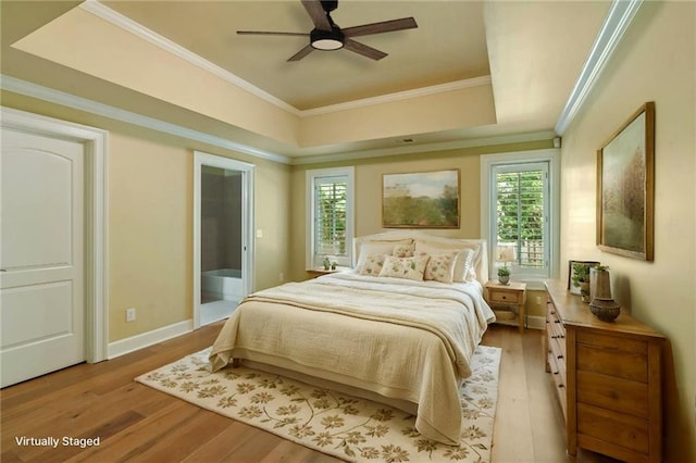 1632 Brookhaven Close NE, Brookhaven, GA 30319 - bedroom featuring multiple windows, light wood-style flooring, a raised ceiling, crown molding, and baseboards