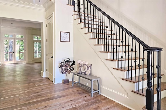 1632 Brookhaven Close NE, Brookhaven, GA 30319 - stairway featuring crown molding, wood finished floors, baseboards, and french doors