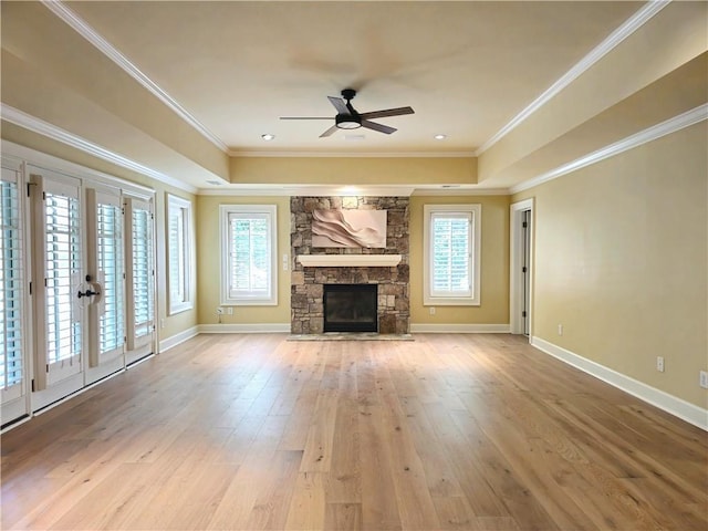 1632 Brookhaven Close NE, Brookhaven, GA 30319 - unfurnished living room with ceiling fan, a tray ceiling, a fireplace, hardwood / wood-style floors, and ornamental molding