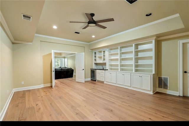 1632 Brookhaven Close NE, Brookhaven, GA 30319 - unfurnished living room with ceiling fan, light wood-style flooring, ornamental molding, bar area, and wine cooler