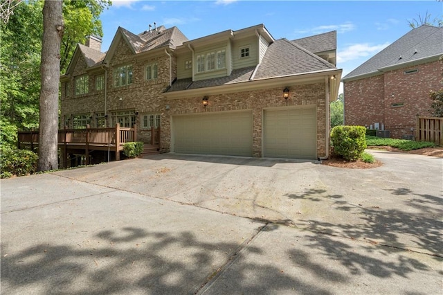 1632 Brookhaven Close NE, Brookhaven, GA 30319 - view of front facade with driveway, brick siding, and a deck
