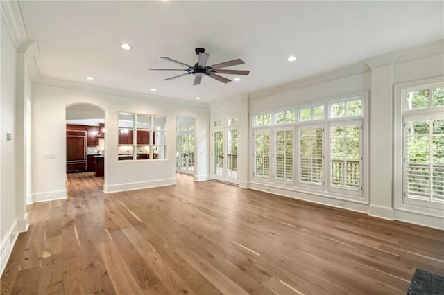 1632 Brookhaven Close NE, Brookhaven, GA 30319 - unfurnished living room featuring arched walkways, ornamental molding, ceiling fan, wood finished floors, and recessed lighting