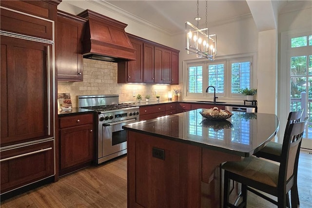 1632 Brookhaven Close NE, Brookhaven, GA 30319 - kitchen featuring stainless steel gas range, premium range hood, a sink, paneled built in fridge, and wood finished floors