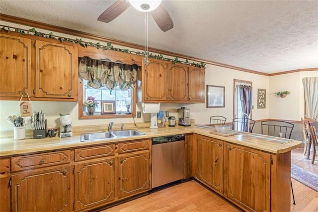 4411 Westerling Ct, Powder Springs, GA 30127 - kitchen with dishwasher, a textured ceiling, a peninsula, crown molding, and brown cabinetry