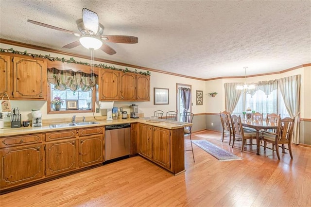 4411 Westerling Ct, Powder Springs, GA 30127 - kitchen with dishwasher, a peninsula, brown cabinets, a textured ceiling, and light wood-style floors