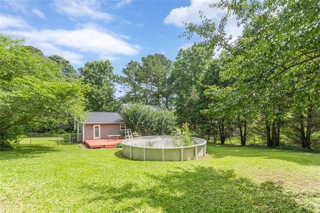 4411 Westerling Ct, Powder Springs, GA 30127 - view of yard with a wooden deck and an outdoor pool