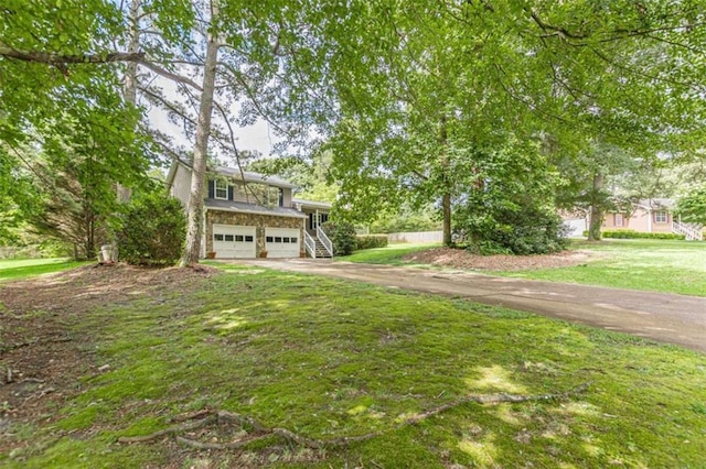 4411 Westerling Ct, Powder Springs, GA 30127 - view of front of home with an attached garage, asphalt driveway, a front yard, and stairway