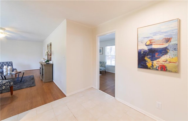 hallway with light wood-style floors and baseboards