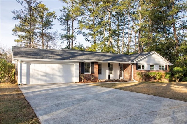 ranch-style home with a garage, brick siding, and driveway