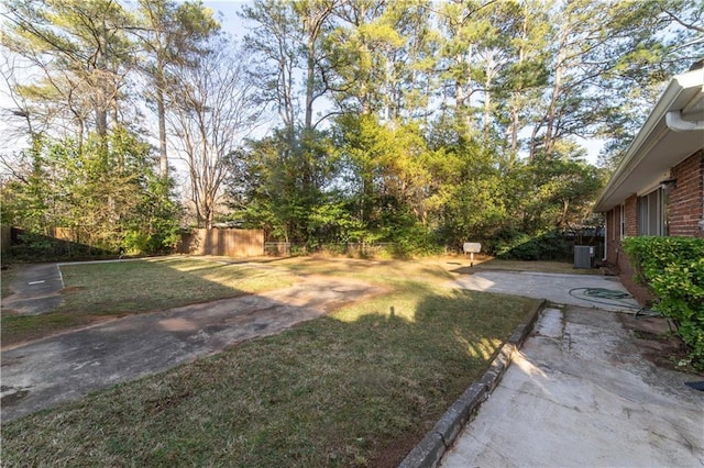 view of yard featuring cooling unit, a patio area, and fence