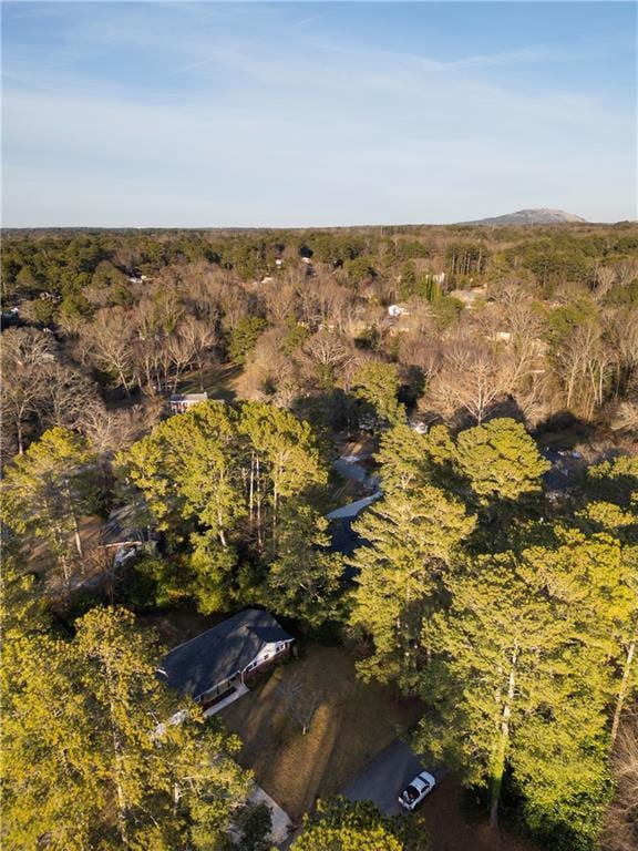 drone / aerial view featuring a wooded view