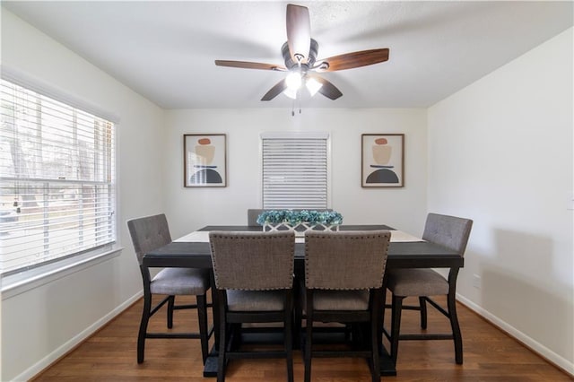 dining room with dark wood-style floors, baseboards, and a ceiling fan