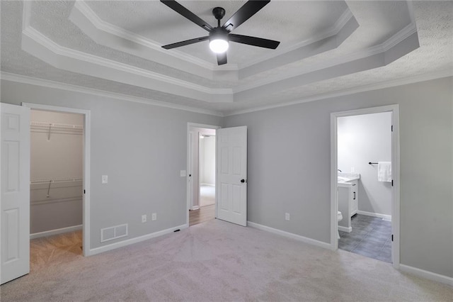 232 Barrett Springs Way, Canton, GA 30115 - unfurnished bedroom featuring a raised ceiling, carpet, ornamental molding, a spacious closet, and ensuite bath