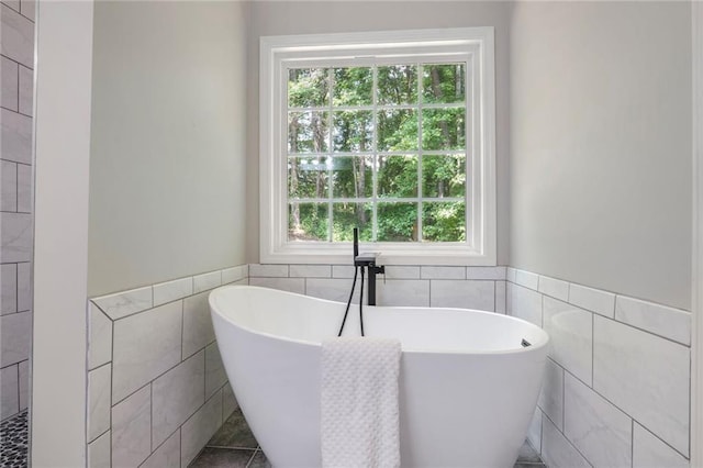 232 Barrett Springs Way, Canton, GA 30115 - bathroom with tile walls, plenty of natural light, a soaking tub, a wainscoted wall, and tile patterned flooring