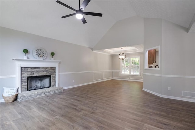 232 Barrett Springs Way, Canton, GA 30115 - unfurnished living room featuring a ceiling fan, vaulted ceiling, a chandelier, a stone fireplace, and wood finished floors